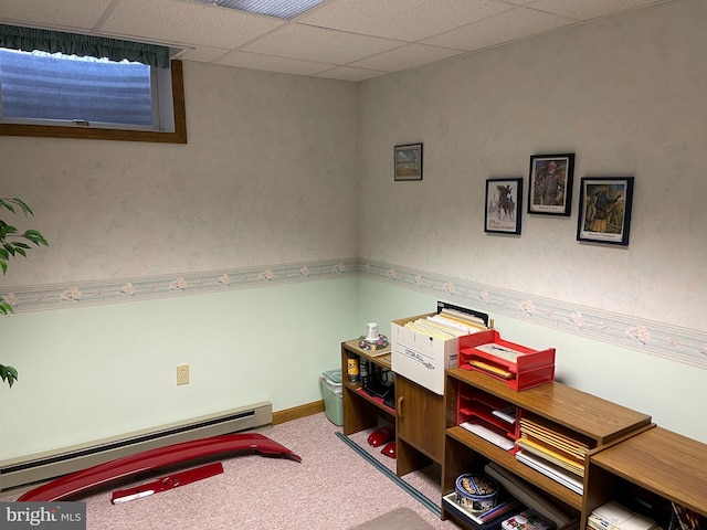 office space featuring a baseboard heating unit, carpet floors, a drop ceiling, and baseboards