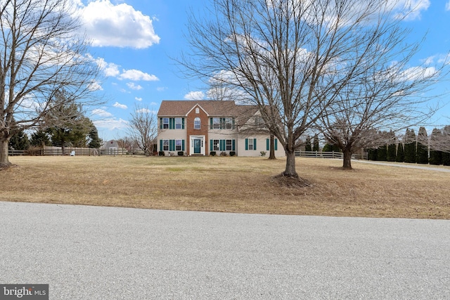 colonial-style house with a front yard