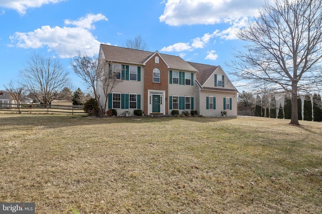 colonial-style house with a front yard