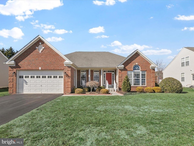 view of front facade with driveway, an attached garage, a front yard, and brick siding