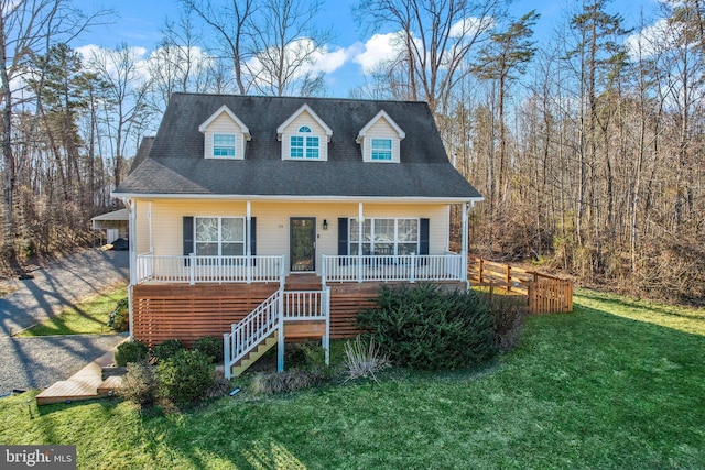 cape cod home with a front yard and a porch