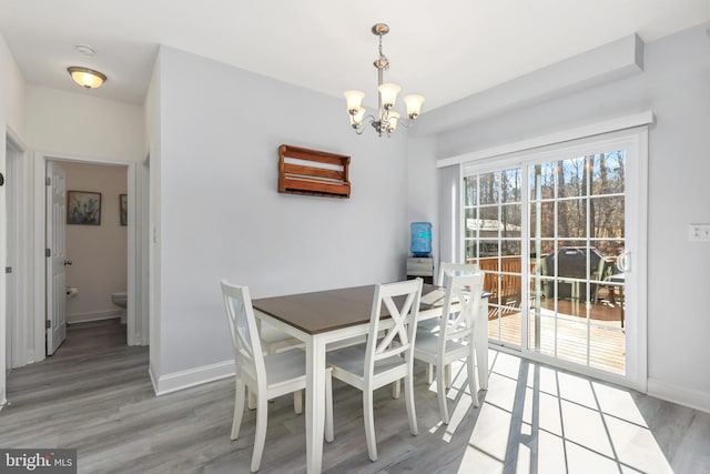 dining room featuring hardwood / wood-style floors and a chandelier