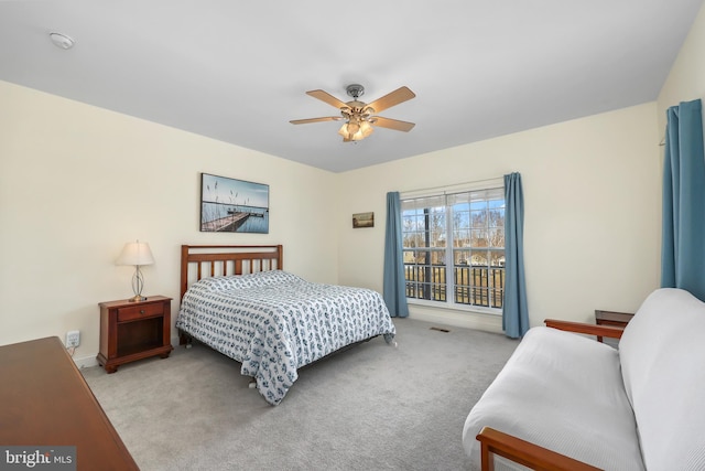 bedroom featuring light carpet and ceiling fan