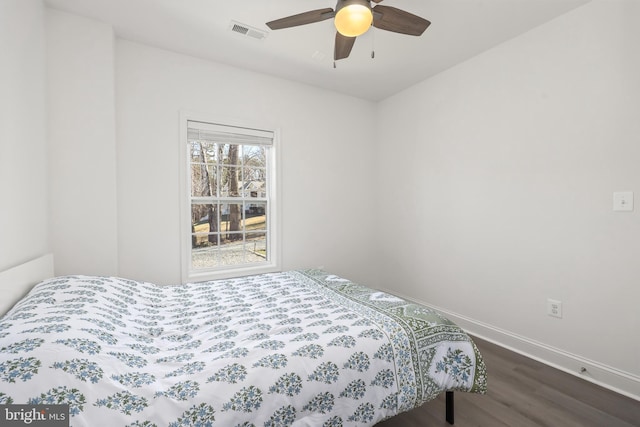 bedroom with ceiling fan and dark hardwood / wood-style flooring