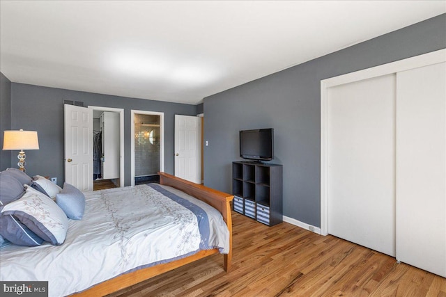 bedroom with wood finished floors and baseboards