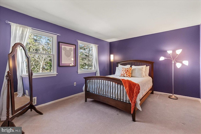 bedroom with carpet floors and baseboards