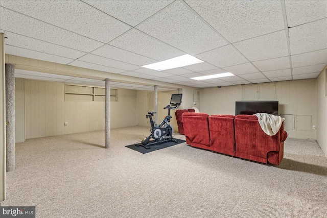 interior space featuring carpet floors and a drop ceiling