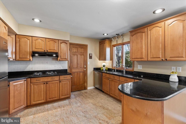 kitchen featuring stainless steel dishwasher, a sink, black gas stovetop, a peninsula, and under cabinet range hood