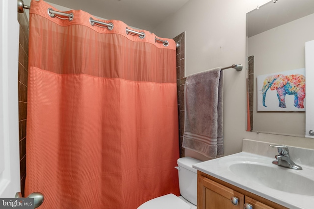 bathroom with vanity, toilet, and a shower with curtain