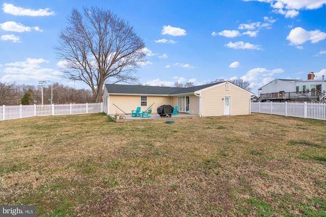 back of house featuring a yard, a fenced backyard, and a patio