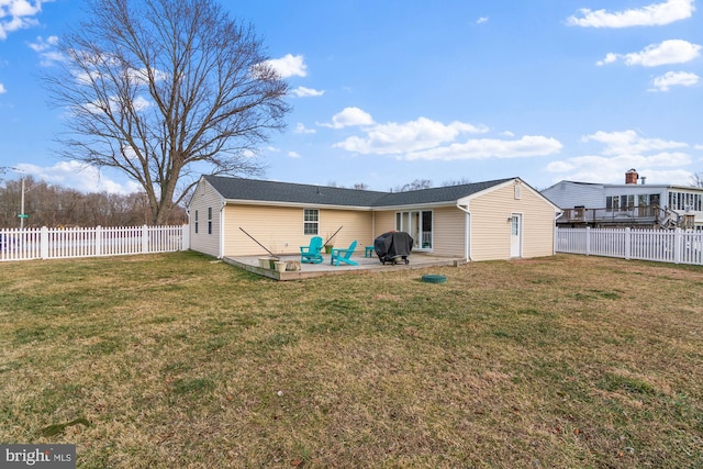 rear view of property featuring a patio, a fenced backyard, and a lawn