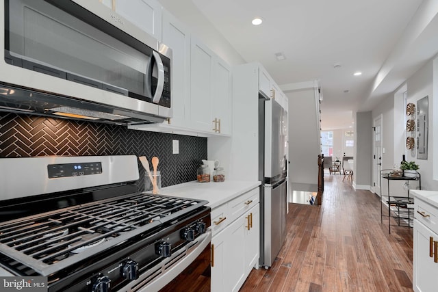 kitchen with stainless steel appliances, light wood-type flooring, white cabinets, and light countertops