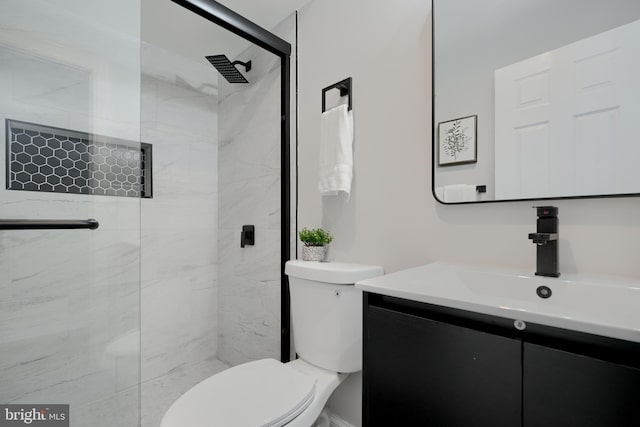 full bath featuring a shower stall, vanity, and toilet