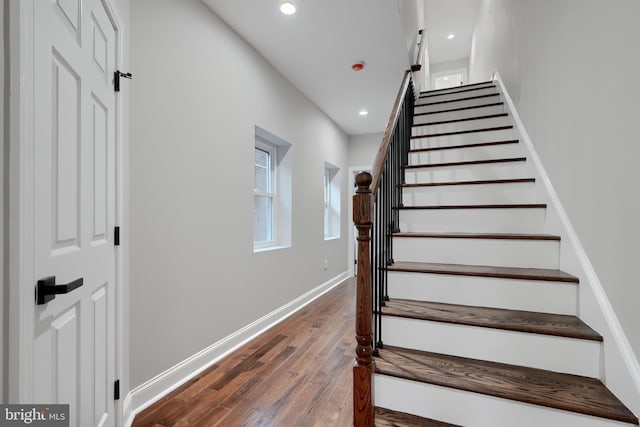 staircase featuring recessed lighting, baseboards, and wood finished floors