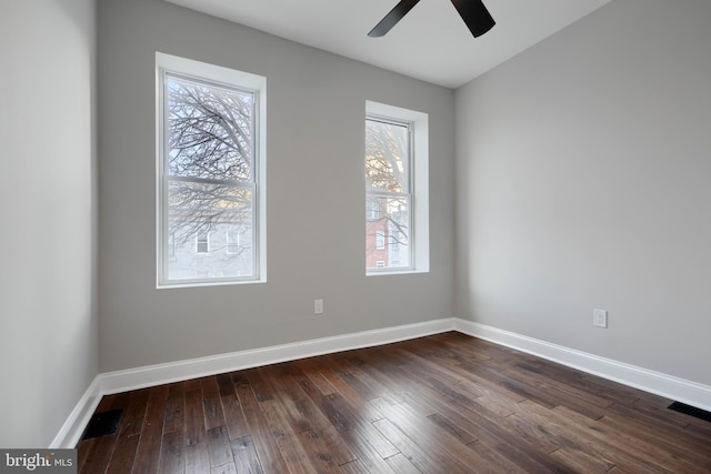 unfurnished room with visible vents, baseboards, a wealth of natural light, and wood finished floors