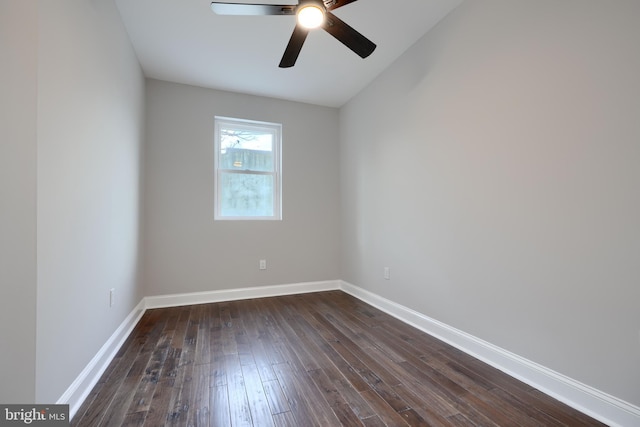 spare room featuring dark wood-type flooring, ceiling fan, and baseboards