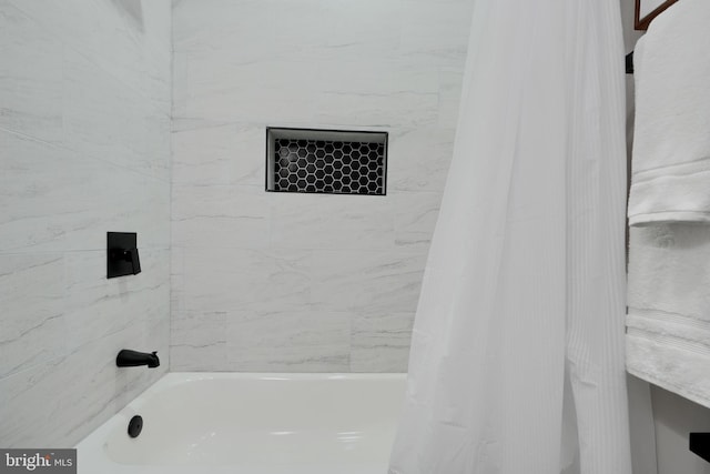 bathroom with shower / bath combination with curtain