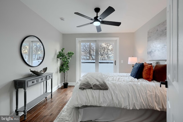 bedroom featuring baseboards, a ceiling fan, lofted ceiling, dark wood-type flooring, and access to exterior