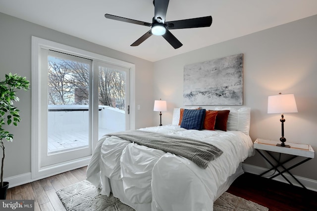 bedroom featuring a ceiling fan, access to outside, baseboards, and wood finished floors