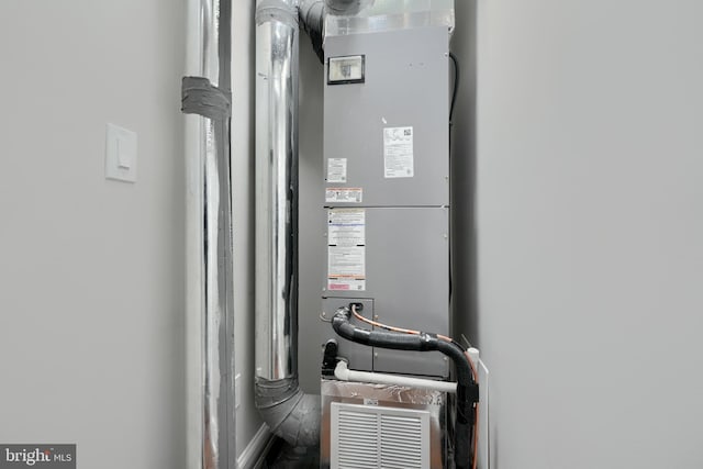 utility room featuring heating unit