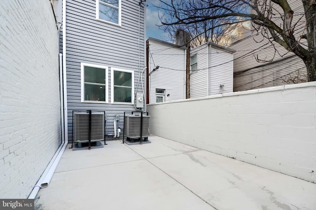 view of patio with fence and central AC unit