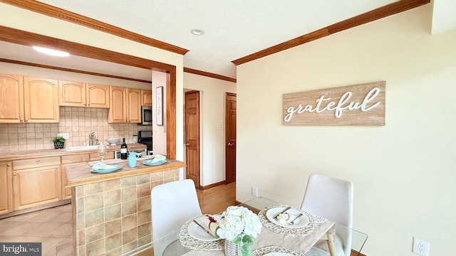 kitchen with sink, crown molding, backsplash, and light brown cabinets