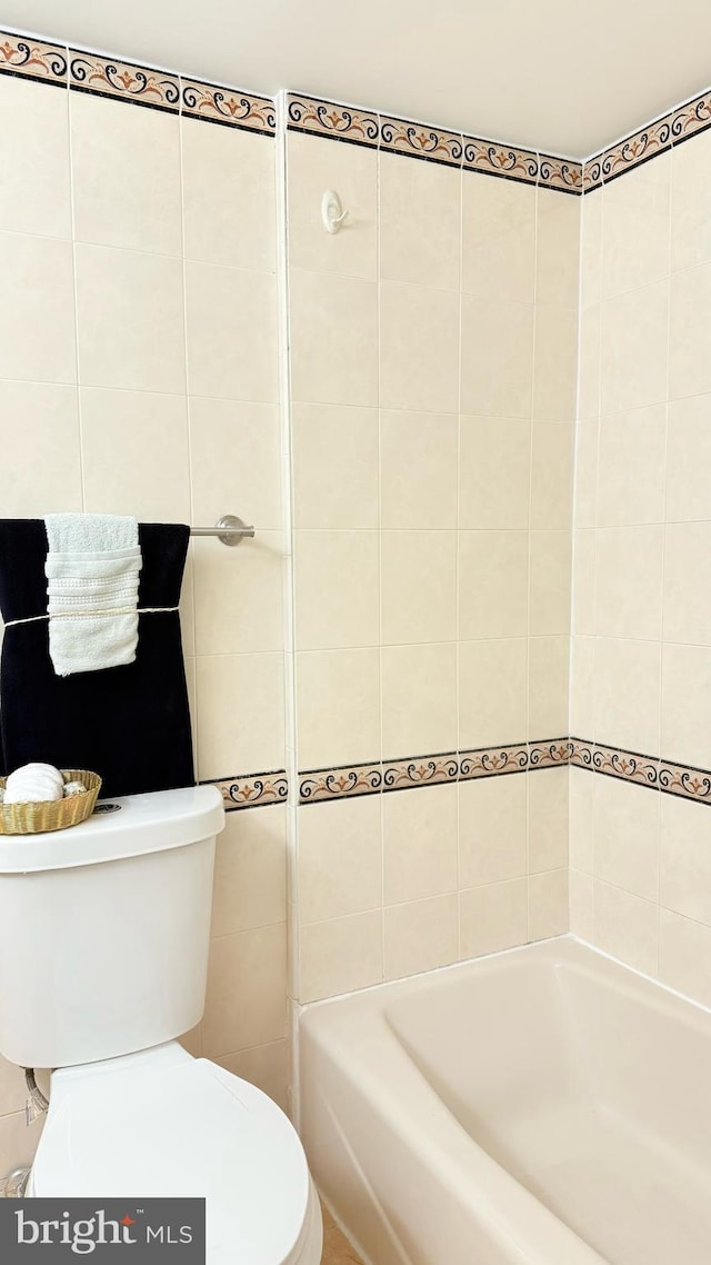 bathroom featuring toilet and a bathing tub