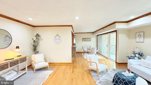 sitting room featuring light hardwood / wood-style flooring and crown molding