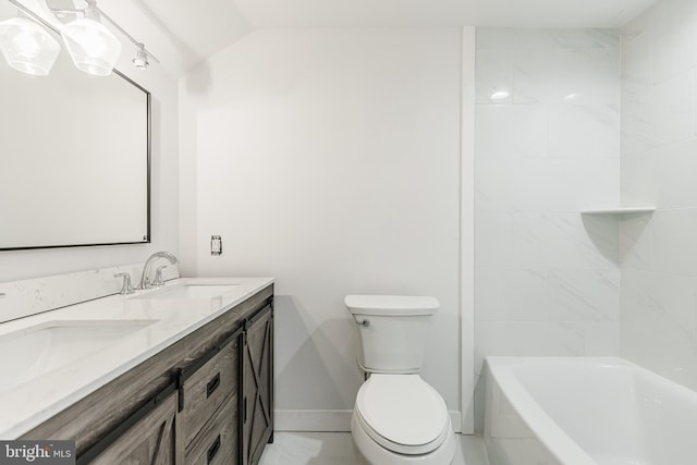 bathroom with lofted ceiling, vanity, and toilet