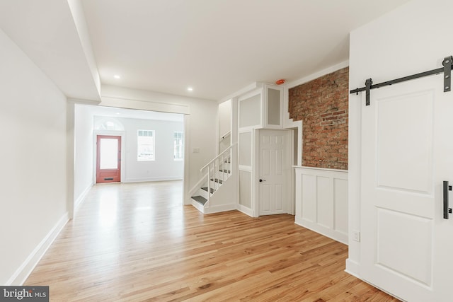 entryway featuring light hardwood / wood-style flooring and a barn door