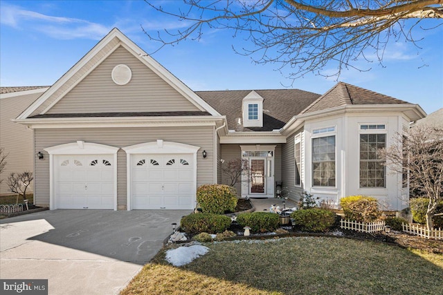 view of front of house with driveway, a garage, and a front lawn