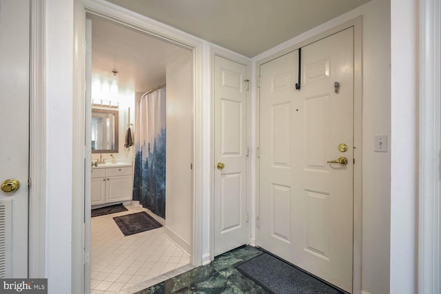 interior space with baseboards, vanity, and a shower with shower curtain