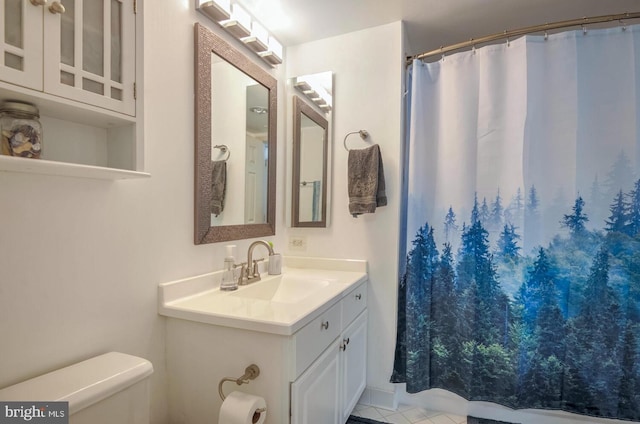 full bathroom featuring vanity and toilet