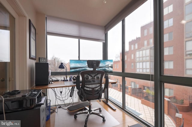 office space with light wood-style flooring and floor to ceiling windows