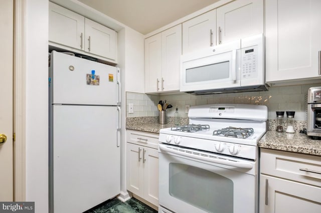 kitchen featuring white appliances, decorative backsplash, and white cabinets