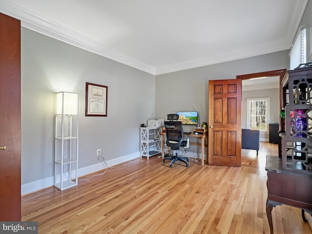 home office with baseboards, light wood-type flooring, and crown molding