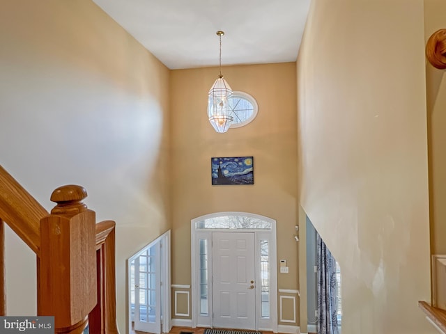 entrance foyer featuring a high ceiling and stairway