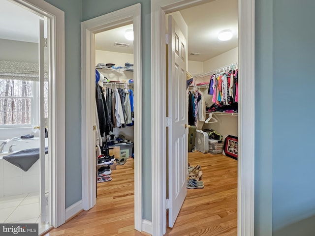 spacious closet featuring visible vents and light wood finished floors