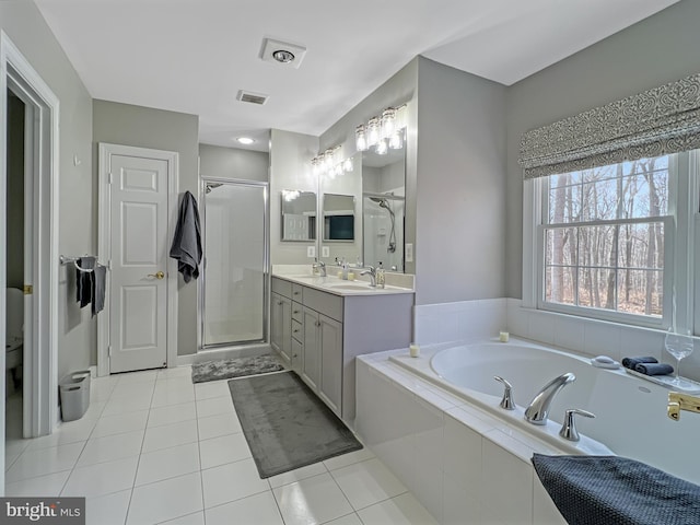 full bathroom featuring visible vents, a bath, tile patterned floors, double vanity, and a stall shower