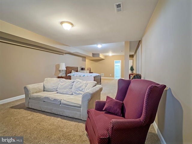 carpeted living room with visible vents and baseboards