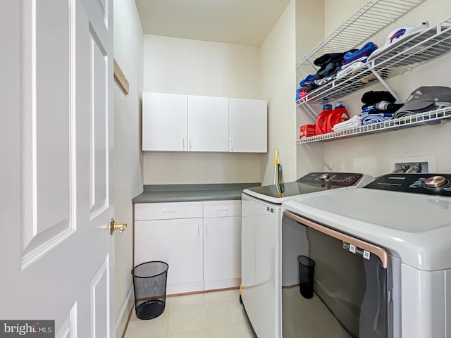 laundry room featuring independent washer and dryer and cabinet space