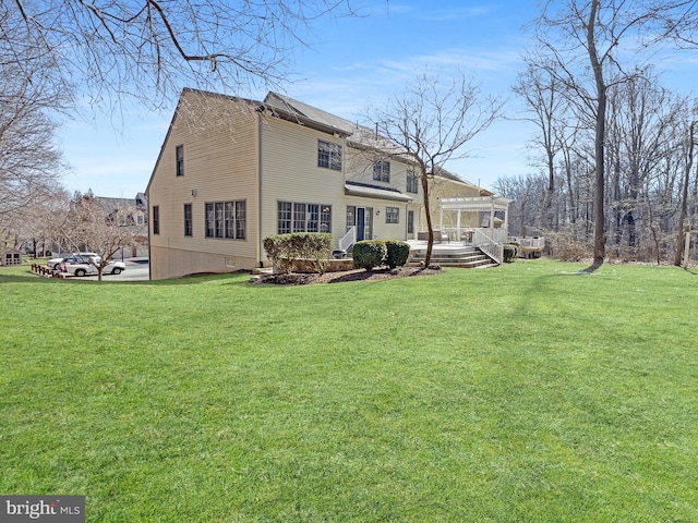 back of property featuring a lawn and a pergola