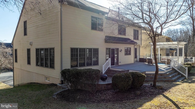 back of property featuring a deck and a pergola