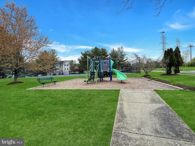 communal playground featuring a yard