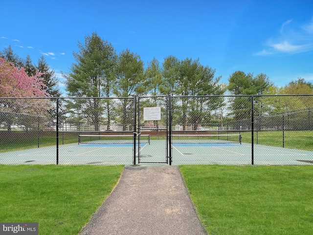 view of sport court featuring a gate, a yard, and fence