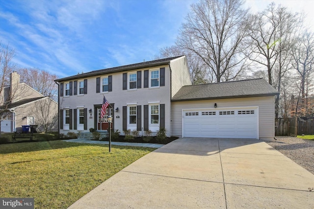 colonial house with concrete driveway, a garage, and a front lawn