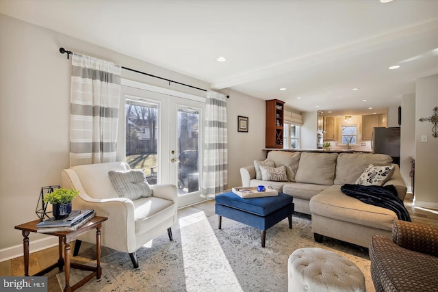 living area with recessed lighting, french doors, light wood-style flooring, and baseboards