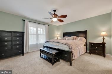 bedroom with light colored carpet, ceiling fan, and baseboards