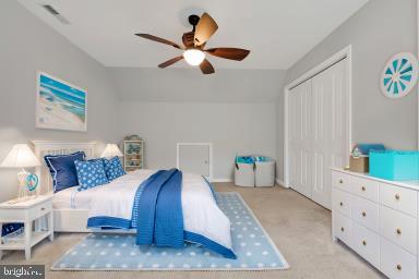 bedroom with visible vents, a closet, and carpet flooring