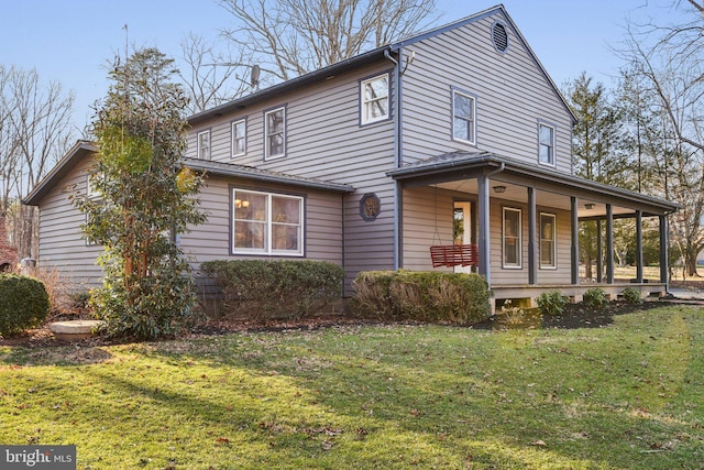 view of front of house featuring a front lawn and covered porch